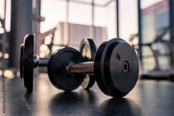 Fototapeta Dumbbell on the floor in luxury clubhouse wait for exercise in the morning