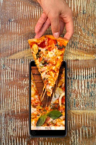 Obraz Seafood pizza Order and food delivery from your smartphone. Smartphone on wooden background