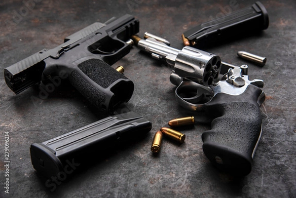 Obraz Gun with ammunition on dark background. 