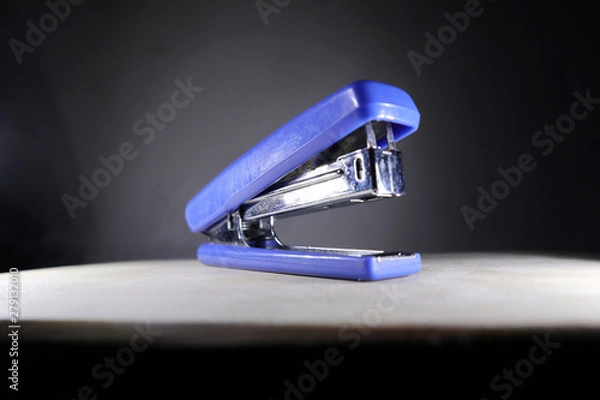 Obraz blue stapler and dark background