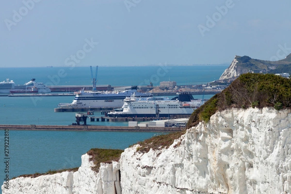 Fototapeta Port of Dover with ferry ships docked in passengers terminal and view over white cliffs, on a sunny summer day, south east England .