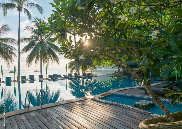 Fototapeta Contour shadow of palm trees at the waterpool on the beach against the sunrise at Phangan island of Thailand