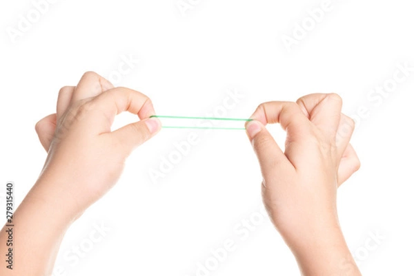 Fototapeta Child hand playing with elastic rubber band isolated on white