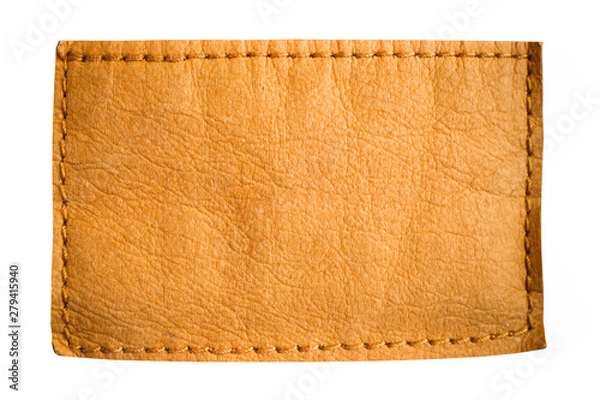 Fototapeta Blank jeans leather label tag in light brown yellow color with clear empty space for text or design isolated on white background.