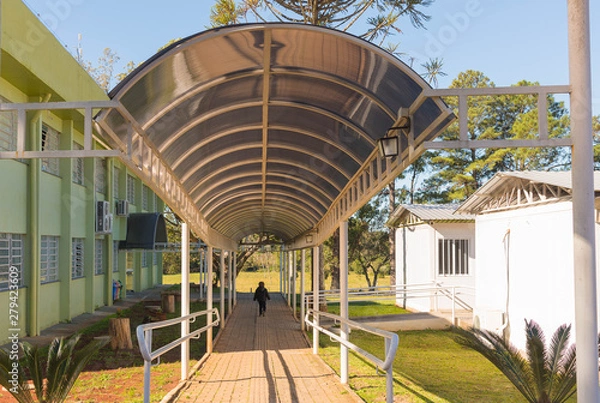 Obraz School and boy walking on walkway