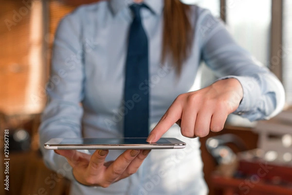 Fototapeta Blurred woman in the background pointing with finger in empty space.