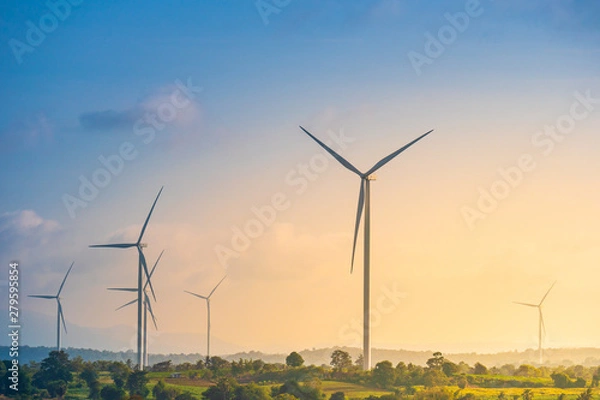 Fototapeta Green energy concept, eco power. Wind turbine located along the hill with the wind blowing all the time. Can produce renewable energy as well. Considered a clean energy.