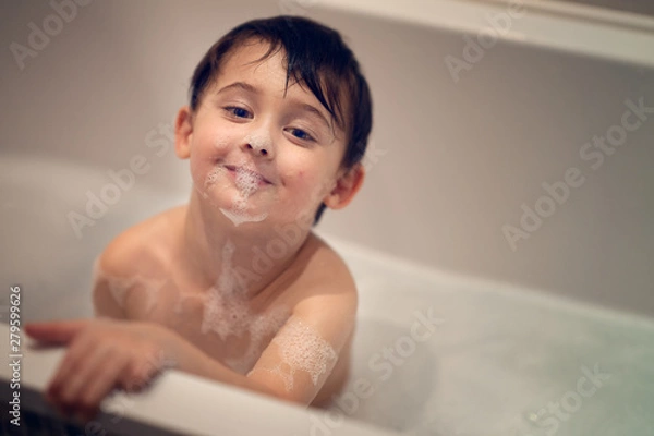 Obraz boy taking bubble bath and looking at the camera