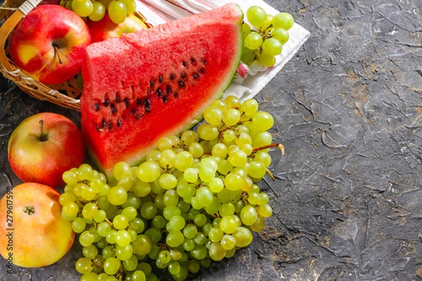 Obraz Watermelon, grapes and apples on a stone background. Autumn harvest.
