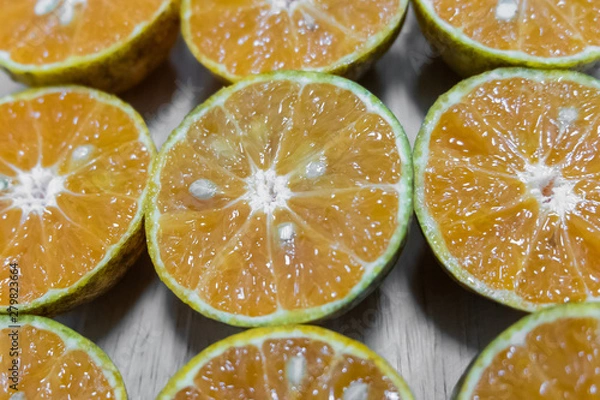 Fototapeta Background of half cut oranges background,soft focus.