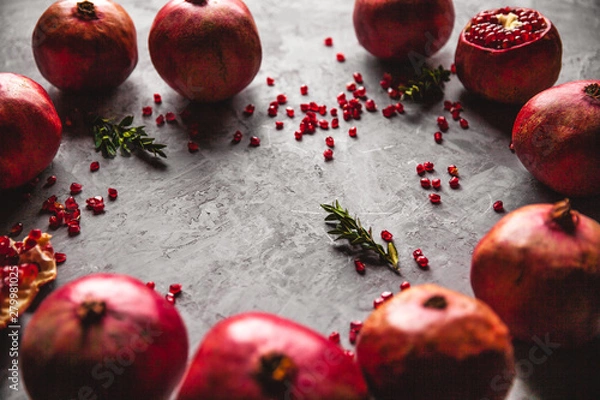 Fototapeta Pomegranate fruit. Ripe and juicy pomegranate on rustic grey background