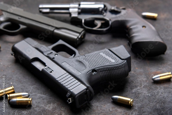 Fototapeta Gun with ammunition on dark background. 