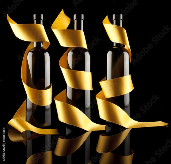Fototapeta Wine bottles with gold ribbon