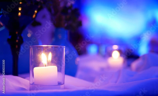 Obraz Small candlelight that have yellow spots on purple light and white background in the room of party of celebration
