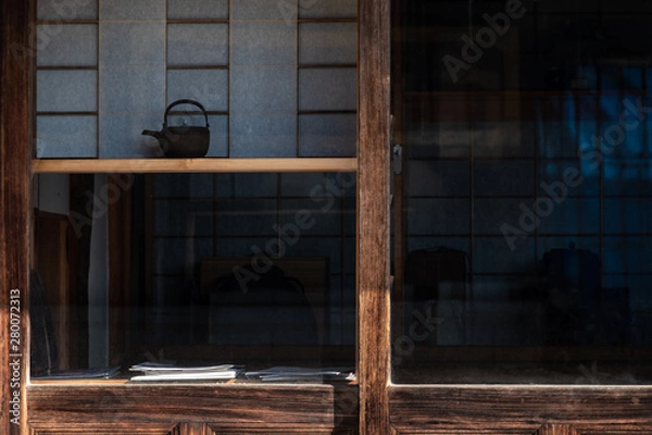 Fototapeta wooden wall of window and old house in Japan. low key and soft focus.