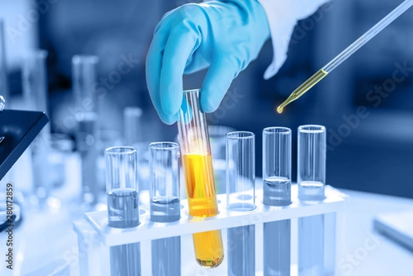 Fototapeta scientist with equipment and science experiments, laboratory glassware containing chemical liquid for research or analyzing a sample into test tube in laboratory
