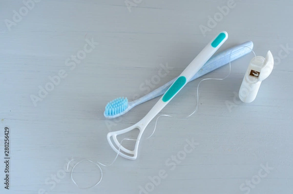 Obraz Oral hygiene health concept. Closeup dental tools toothbrush and tongue cleaner