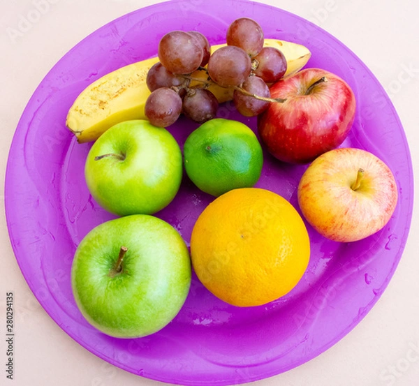 Fototapeta Fruits on a purple tray viewed from above