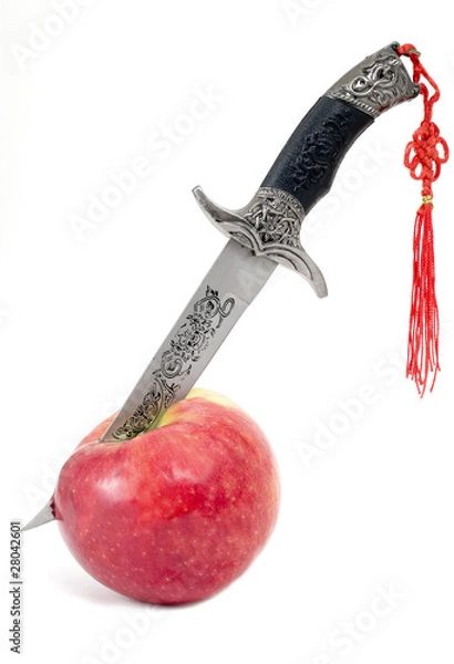 Obraz Dagger in  ripe apple on a white background