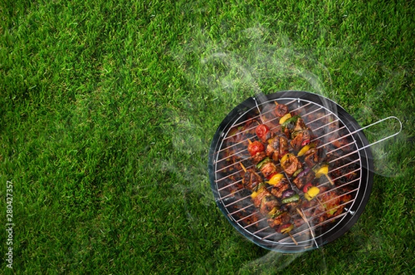 Fototapeta Shashlik on barbecue in the garden