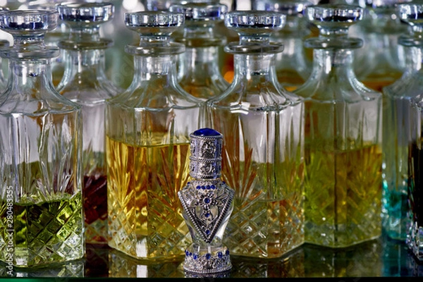 Obraz Glass perfume bottles based oils. A Bazaar, market. Aroma oils, oil perfume in faceted glass vessels.