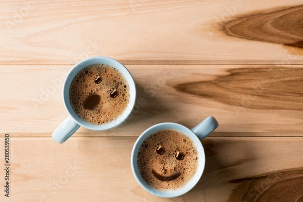Fototapeta froth milk foam smiles in a cup of coffee in morning.