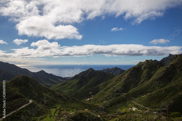 Fototapeta View of winding road go through green hills to atlantic ocean. Beautiful mountains on the Sao Miguel island, Azores