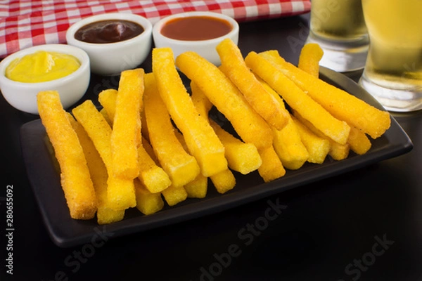 Obraz Traditional Brazilian recipe fried polenta in black background