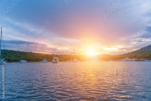 Fototapeta calm bay at evening with moored yachts