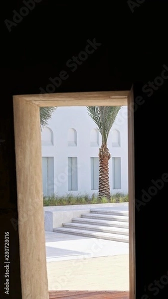 Fototapeta View from inside to bright sunny space through open door