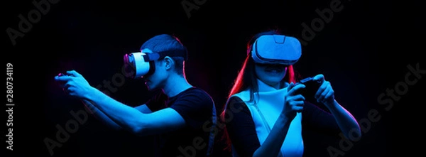 Fototapeta Couple with virtual reality headset are playing game.