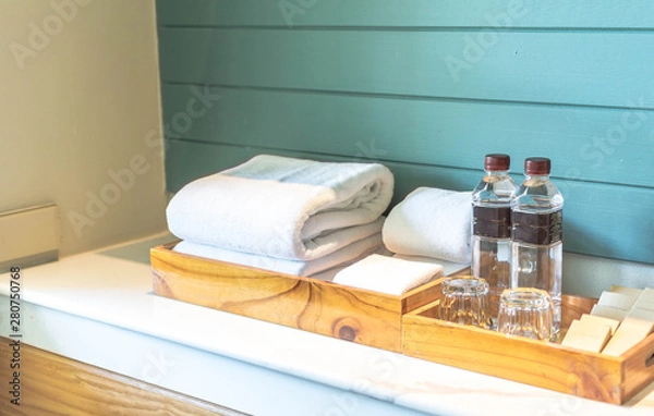 Fototapeta A set of hotel toiletries with white clean towel in a bathroom, copy space
