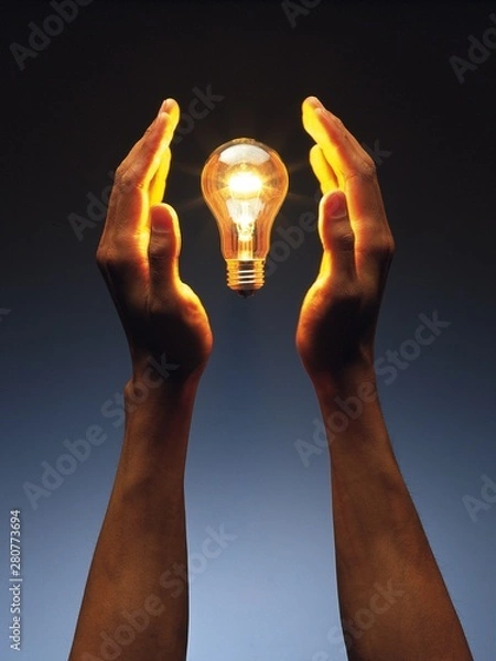 Obraz hand holding light bulb