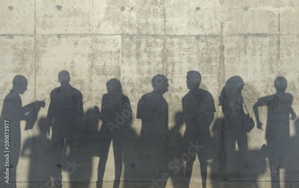 Obraz Group of people walking in a relaxed pose cast a shadow on the concrete wall. Conceptual creative illustration with silhouettes of men and women. Copy space. 3D rendering.