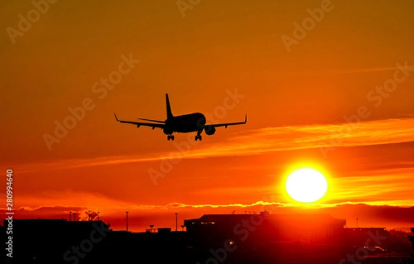 Fototapeta Airplane landing to airport runway