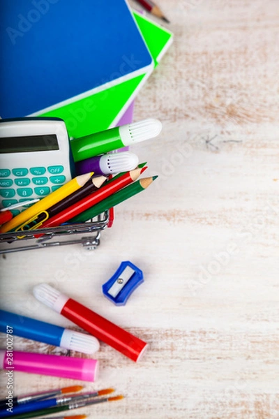 Fototapeta Items for school in a shopping cart.