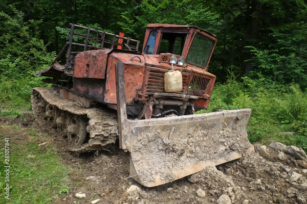 Fototapeta Old red skidder on the road in Carpathian forest