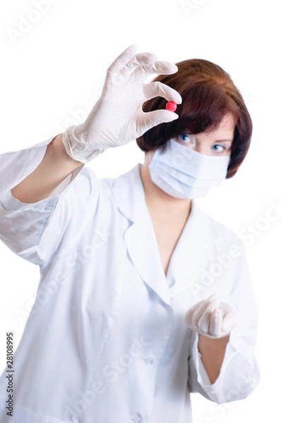 Obraz Doctor looking at red round pill