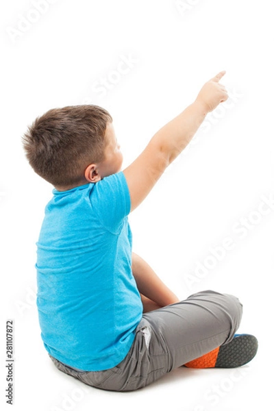 Obraz Adorable little boy pointng at wall. Isolated on white background 