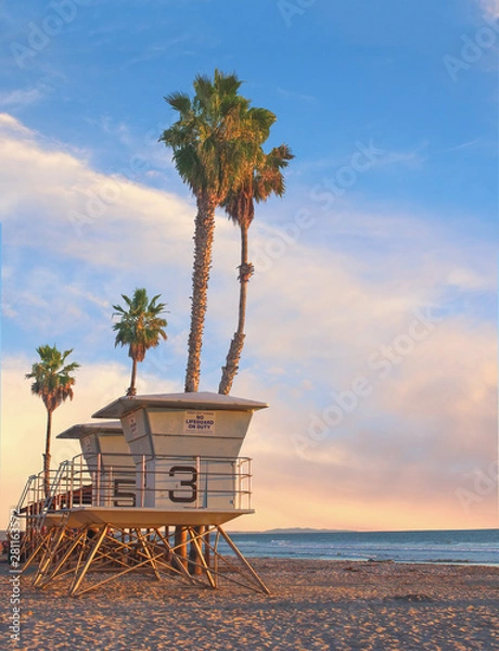 Obraz Life guard tower –  Life guard tower with palm trees at sunset in California    
