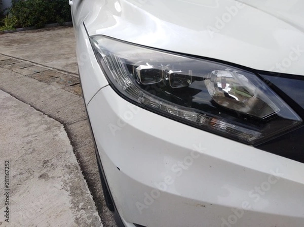 Fototapeta White car front headlight with shallow depth of field