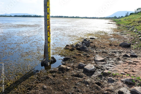 Obraz  Water measurement scale appear after water in lake are very low level.