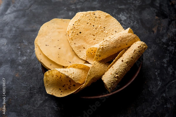 Obraz Gujarati papad or papadum in raw dried form with roasted cone, roll and flat variation