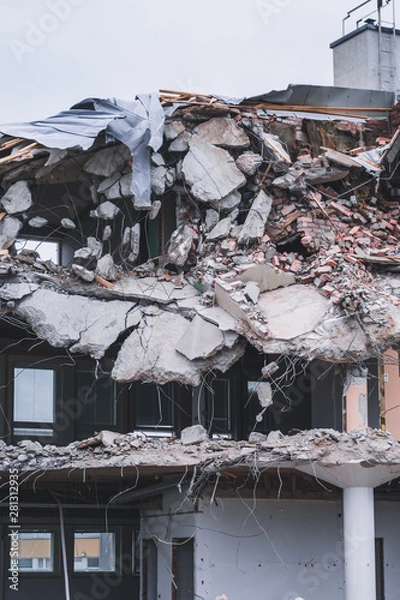 Fototapeta Building been torn down by the demolition team on a spring day