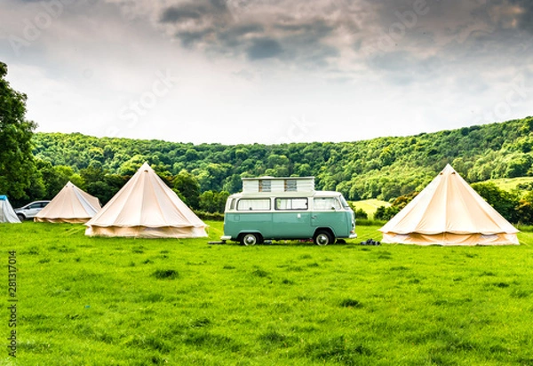 Fototapeta An iconic camper van at a glamping site in the English countryside