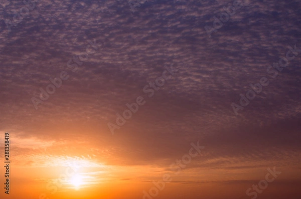 Obraz Dramatic dark sunset with bright sunshine and dark clouds.