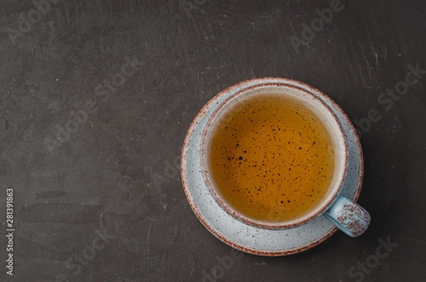Fototapeta Blue cup of tea on dark stone background, top view and copyspace for text