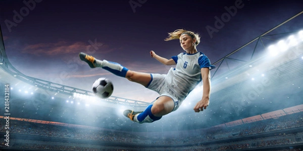 Obraz Female Soccer player in action on a professional soccer stadium. Girl playing soccer