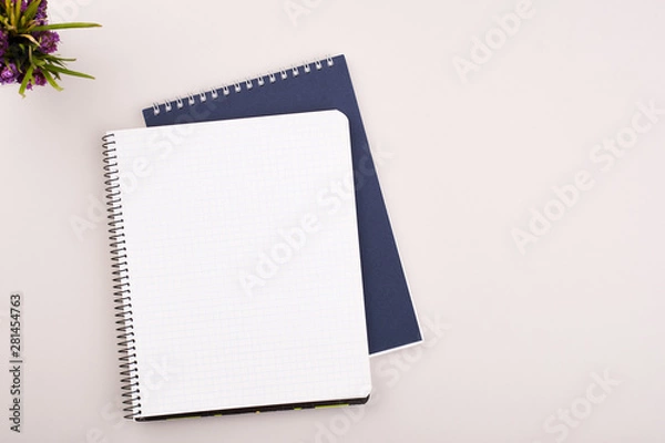 Obraz Planner on the grey wooden working table. Blank white paper on working desk