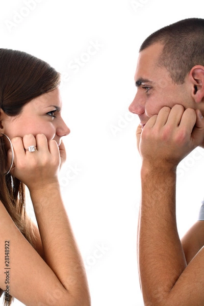 Fototapeta Young couple looking at each other isolated on white